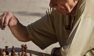 Old retired man playing chess at the Jardins du Luxembourg, Paris